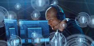 Man with headset working at computer holographic icons