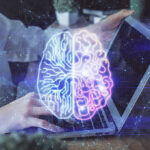 Futuristic AI brain hologram above a laptop computer