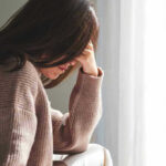 Person with head down looking distressed or contemplative