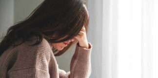 Person with head down looking distressed or contemplative