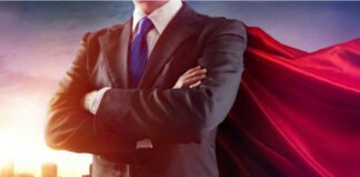Businessman wearing a cape standing confidently