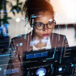 A woman analyzing data on a futuristic digital interface