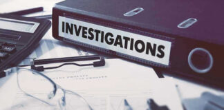 Documents and binder labeled Investigations on desk.