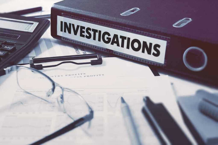 Documents and binder labeled Investigations on desk.