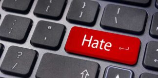 Close-up of a keyboard with a red key labeled Hate