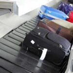 Various suitcases on an airport luggage carousel