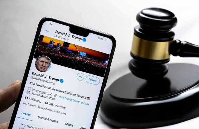 Smartphone displaying Twitter profile near a judges gavel.