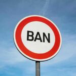 A road sign displaying the word 'BAN' against a blue sky