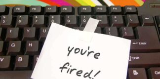 A note saying 'you're fired!' taped to a computer keyboard