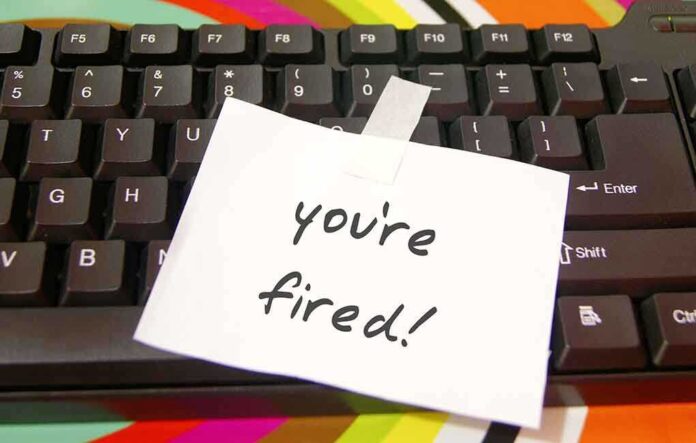 A note saying 'you're fired!' taped to a computer keyboard