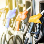 Colorful gas pump nozzles at a station.