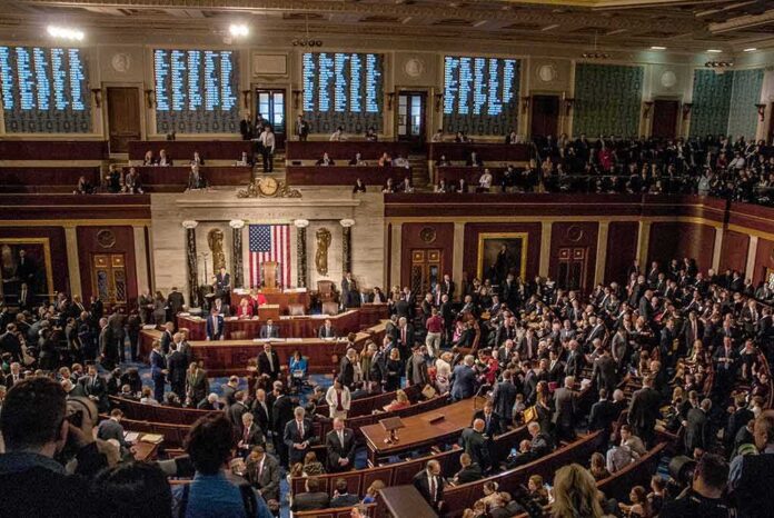 A crowded congressional chamber with members in discussion
