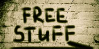 Graffiti on a brick wall stating FREE STUFF with an arrow