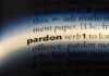 The word pardon highlighted in a dictionary.