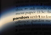 The word pardon highlighted in a dictionary.