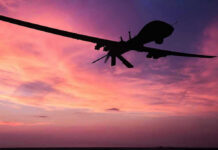 CARTEL DRONES Breach U.S. Airspace Silhouette of a drone against a colorful sunset.