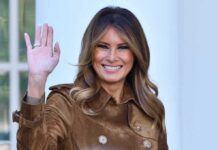Melania WARDROBE Shocks D.C. Melania Trump waving and smiling while wearing a stylish coat