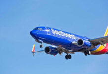 Southwest Airlines plane flying in blue sky.