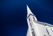 A tall church steeple against a clear blue sky