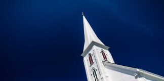 A tall church steeple against a clear blue sky