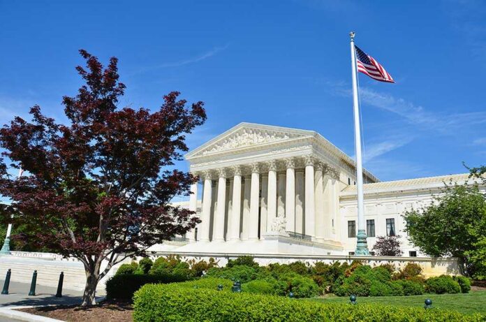Supreme Court building with American flag and surrounding greenery