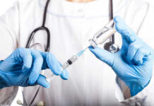 FDA Blocks PROMISING Melanoma Drug—Patients in Despair Doctor filling syringe with vaccine from vial.
