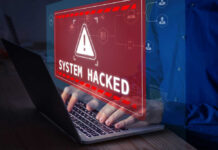Hacker Heist: Schools Held HOSTAGE! Warning sign System Hacked on laptop screen.