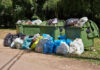 Democrat BUSTED – 1,000 Fake Voters in Garbage Bag Overflowing garbage bins with bags on the ground.